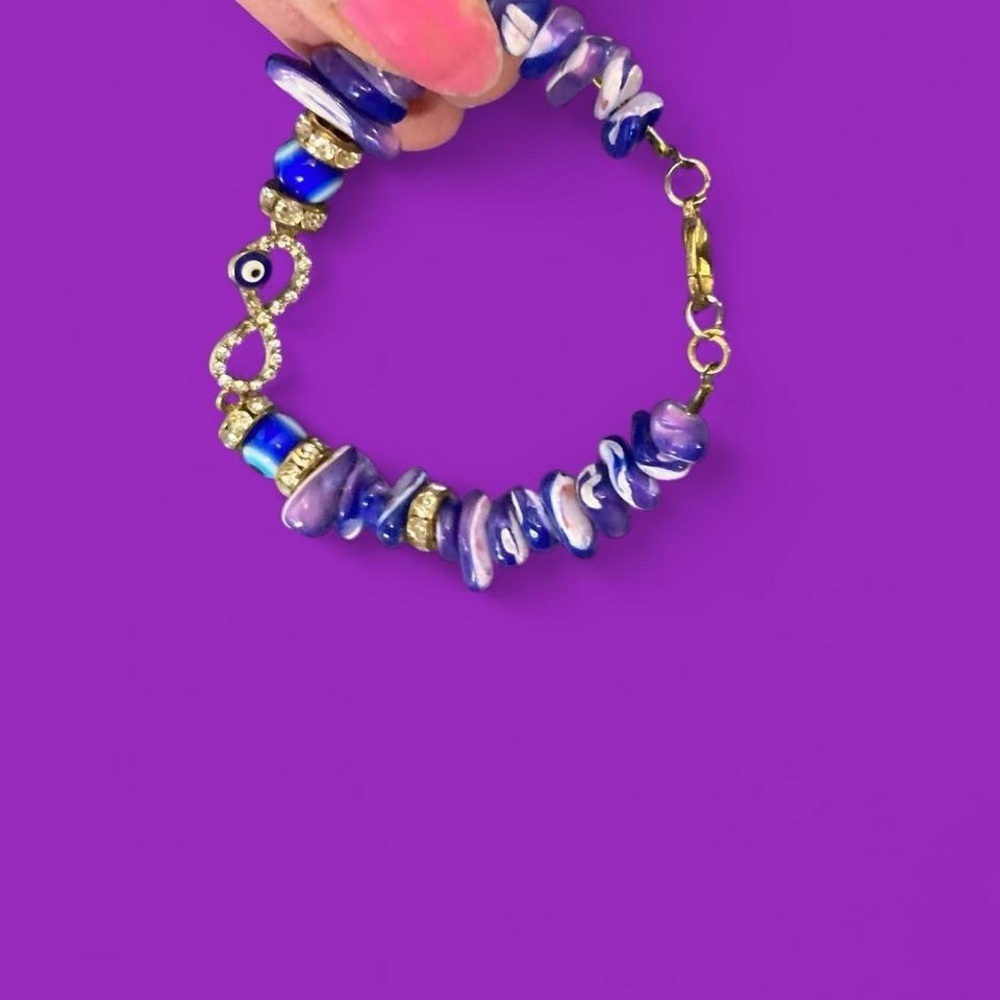 Gold toned Blue and white beaded bracelet with gold accents and evil eye